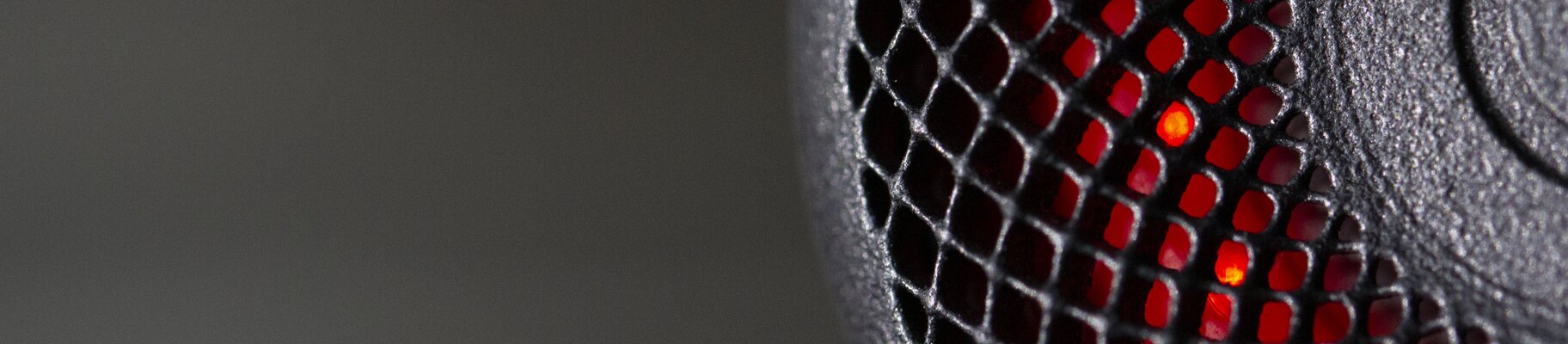 © EOS Close-up of a 3D printed bike light housing glowing red | © EOS
